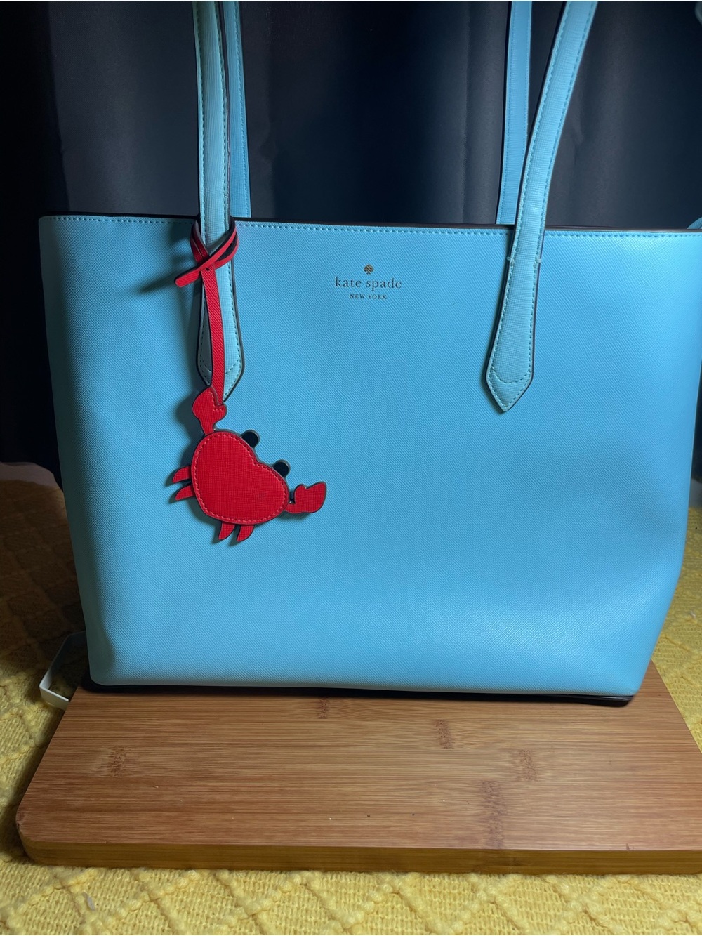 kate spade leather tote in bright blue with red crab charm
